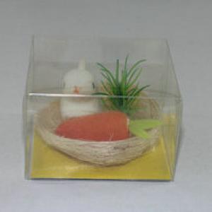 Easter bunny with carrot and grass in nest